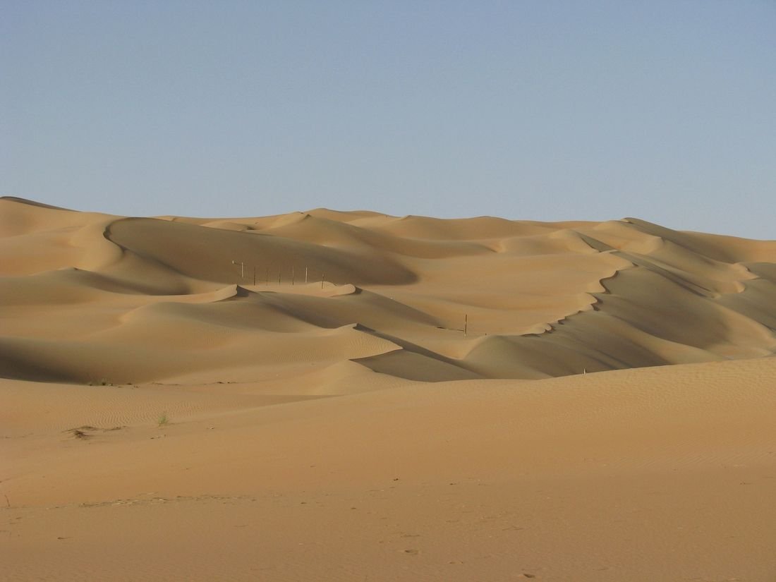 Red sand dunes beside the desert road from Dubai to Al Ain