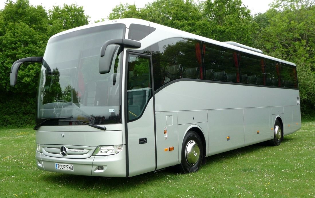 White 50-seat coach on a trade-show stand