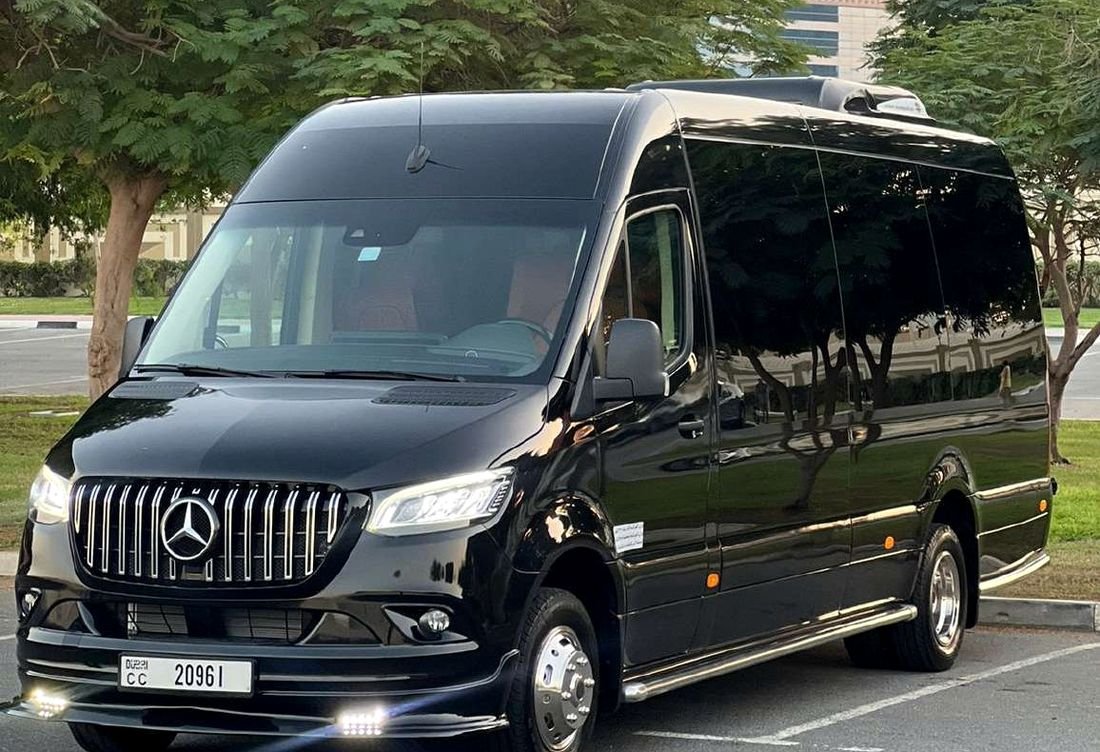 Black Mercedes Sprinter VIP minibus at sunset