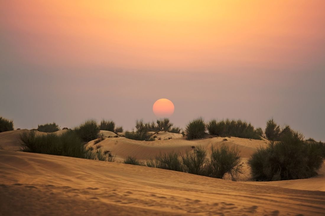 Desert and mountains at sunset on the road east from Dubai