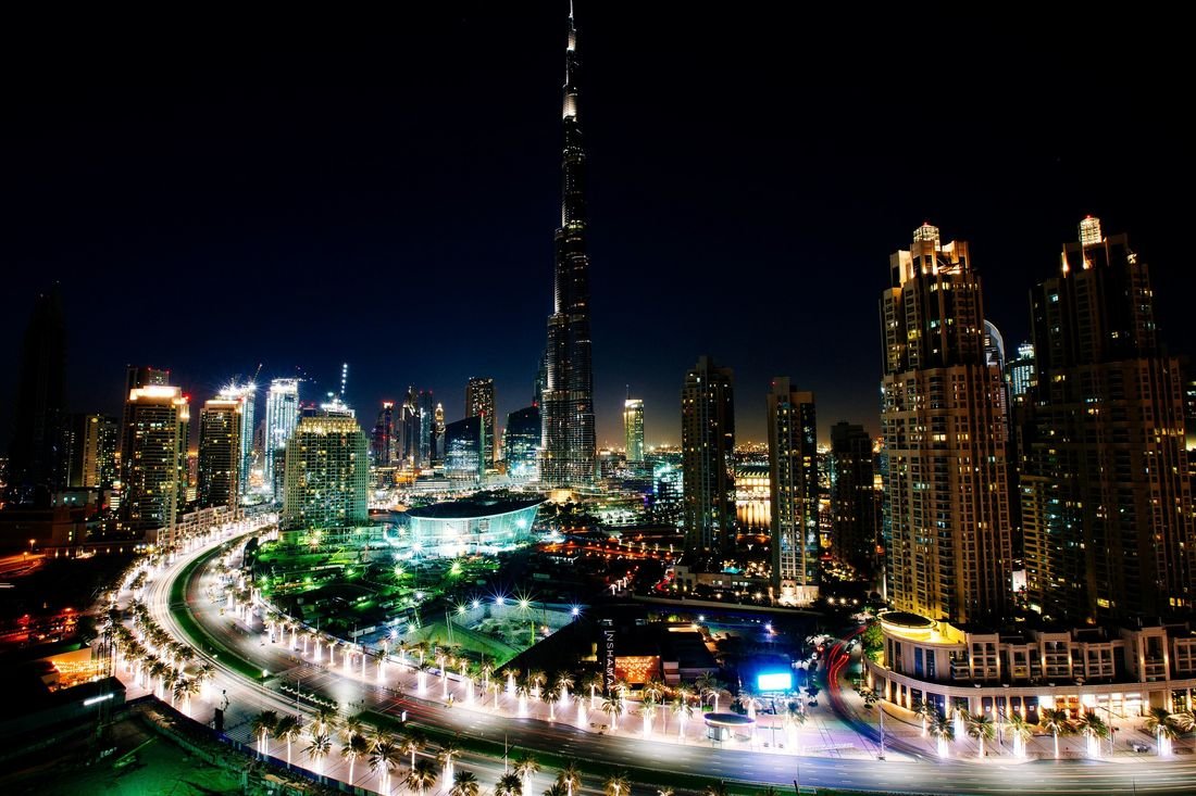 Downtown Dubai at night with Burj Khalifa above the boulevard