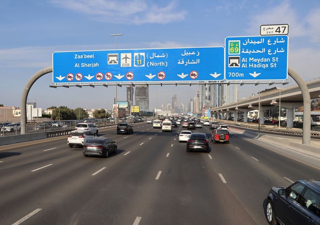Overhead direction signs above Sheikh Zayed Road in Dubai
